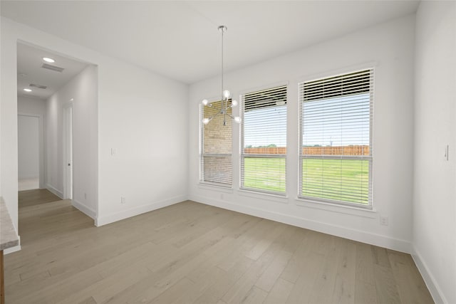 431 Broadmoor, Ovilla, TX 75154 - unfurnished dining area with baseboards, a chandelier, and light wood-style flooring