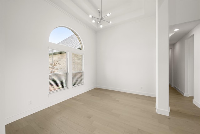 431 Broadmoor, Ovilla, TX 75154 - spare room featuring a chandelier, ornamental molding, light wood finished floors, baseboards, and a high ceiling