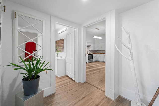 hallway featuring light wood finished floors