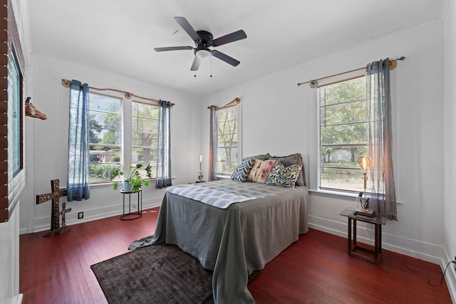 bedroom featuring crown molding, baseboards, a ceiling fan, and hardwood / wood-style flooring
