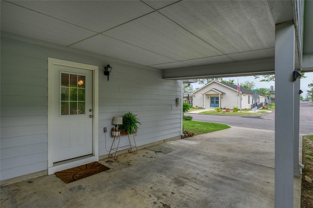 310 Otis St, Whitesboro, TX 76273 - doorway to property with an attached carport and a residential view