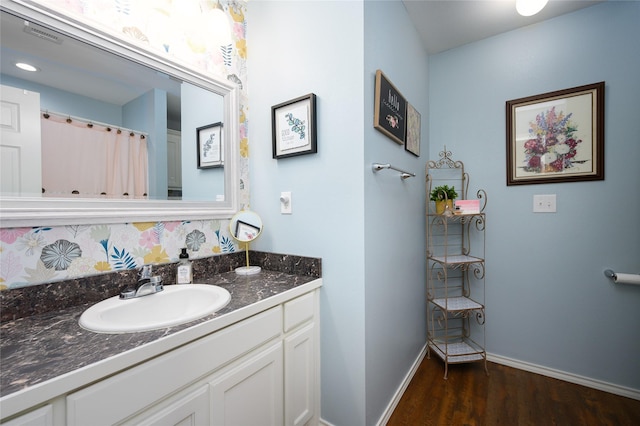 310 Otis St, Whitesboro, TX 76273 - full bath featuring vanity, wood finished floors, tasteful backsplash, and baseboards