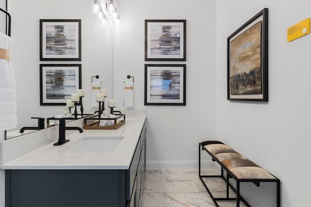 bar with baseboards, marble finish floor, and a sink