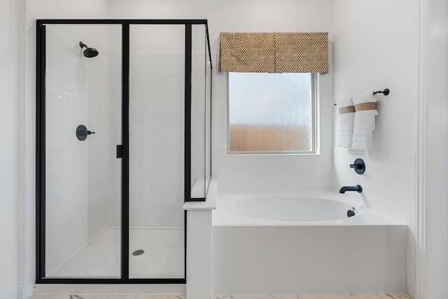 full bath featuring a bath and a stall shower