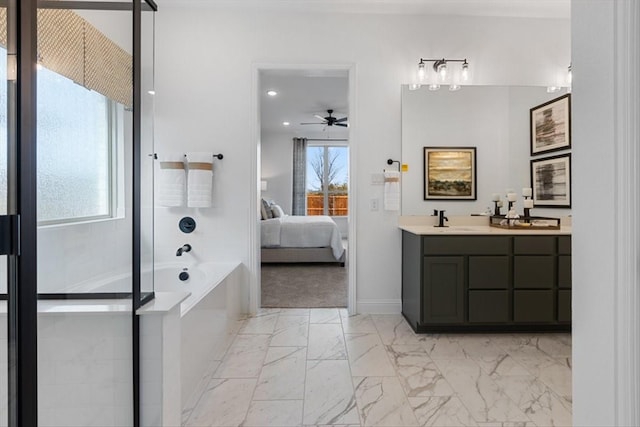 ensuite bathroom with a garden tub, vanity, marble finish floor, ceiling fan, and ensuite bath