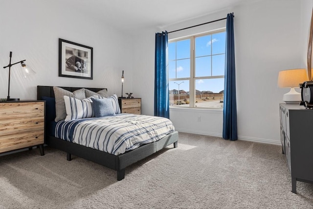 bedroom featuring carpet flooring and baseboards