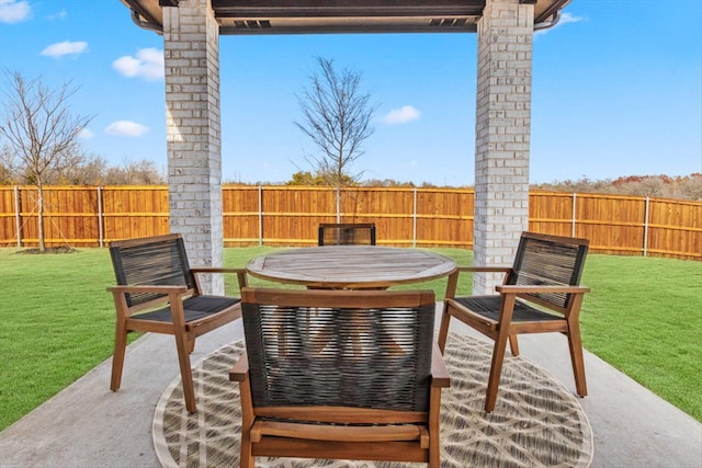 view of patio featuring a fenced backyard and outdoor dining area