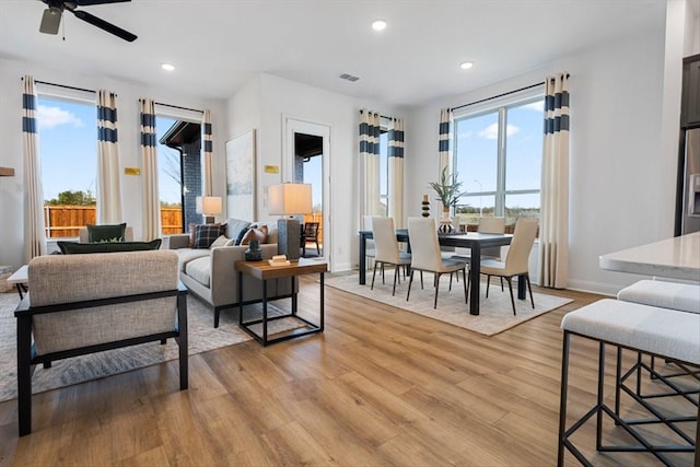 living area with recessed lighting, a ceiling fan, visible vents, and light wood-style flooring