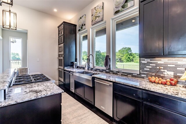 kitchen featuring backsplash, a center island, a sink, stainless steel appliances, and dark wood-type flooring