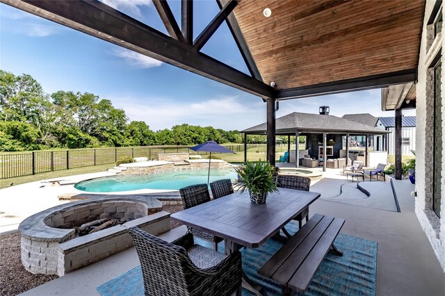 view of patio / terrace with area for grilling, fence, outdoor dining space, and a fenced in pool