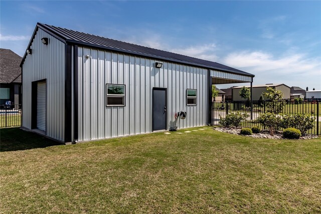 view of outbuilding featuring fence and an outbuilding