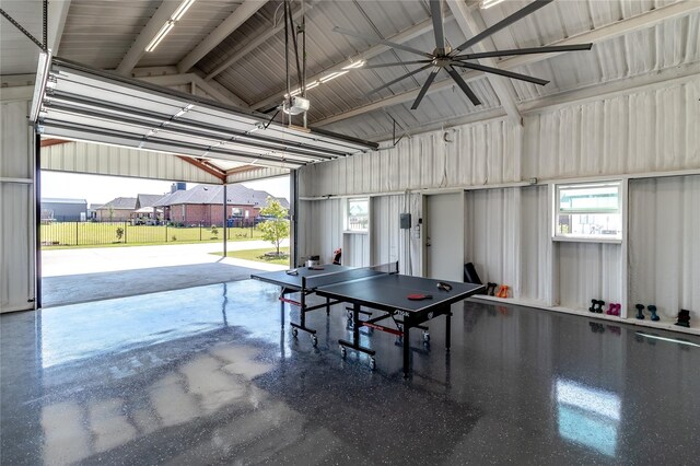 playroom with a garage, ceiling fan, vaulted ceiling, and metal wall