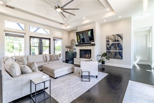 kitchen with dark wood-style flooring, light stone countertops, a fireplace, recessed lighting, and ceiling fan with notable chandelier