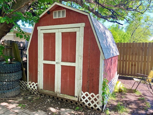view of shed featuring fence