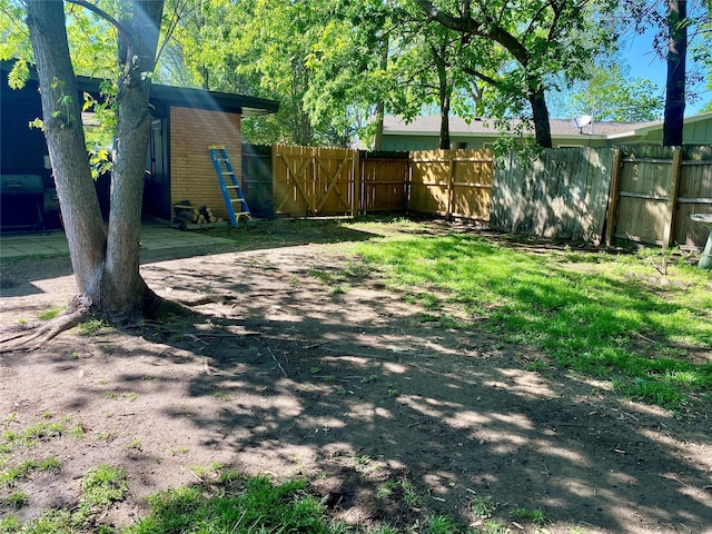 view of yard featuring fence and a gate