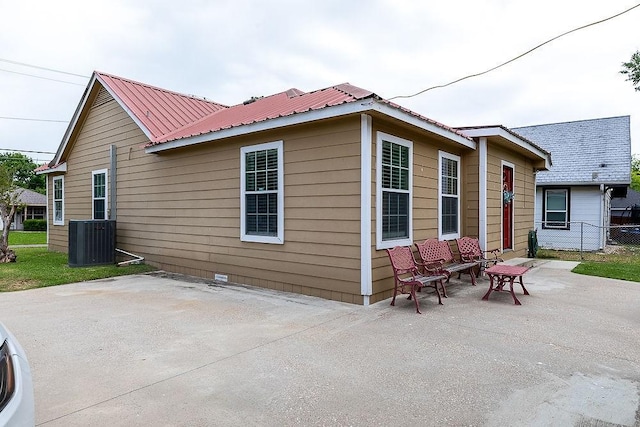 2617 Bourland St, Greenville, TX 75401 - rear view of property featuring a patio area, central air condition unit, fence, metal roof, and crawl space