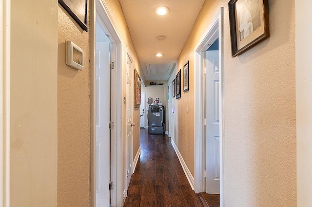 2617 Bourland St, Greenville, TX 75401 - corridor featuring attic access, dark wood-style flooring, a textured wall, baseboards, and recessed lighting