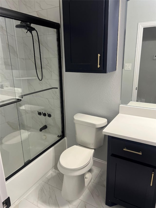 full bathroom with marble finish floor, toilet, vanity, baseboards, and bath / shower combo with glass door