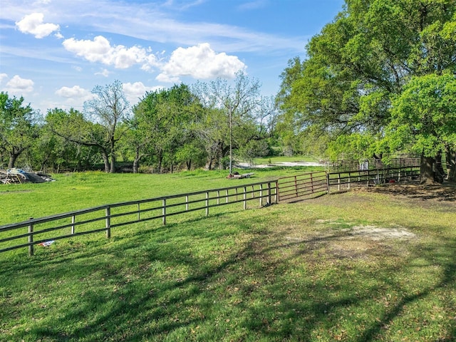 view of yard featuring fence and a rural view