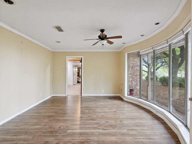 unfurnished room featuring baseboards, visible vents, ornamental molding, and ceiling fan