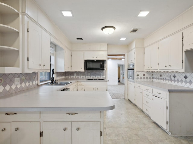 kitchen with black appliances, decorative backsplash, and a sink