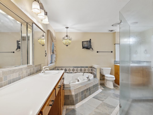 full bathroom with tile patterned flooring, a shower stall, toilet, vanity, and a garden tub