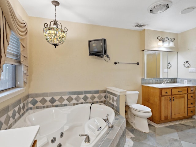 bathroom featuring visible vents, toilet, a whirlpool tub, and vanity