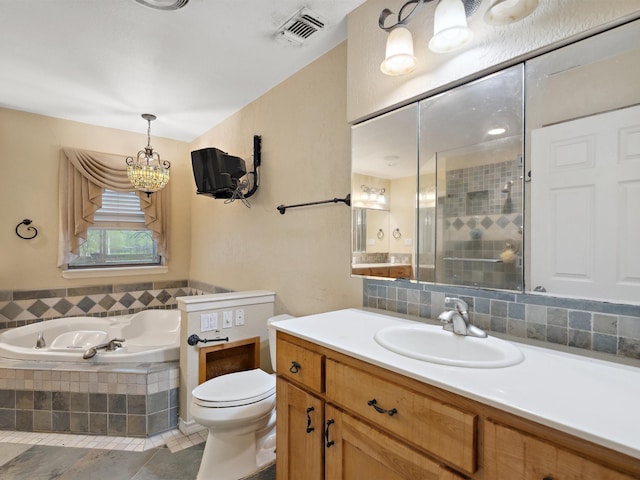 bathroom with a shower stall, vanity, visible vents, a notable chandelier, and a garden tub