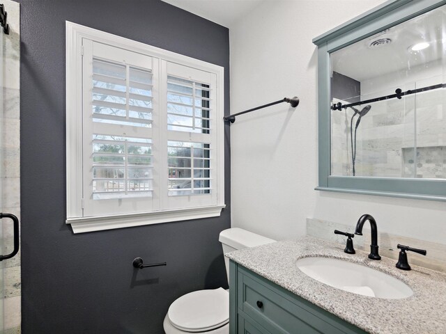 full bath featuring visible vents, a shower stall, toilet, and vanity