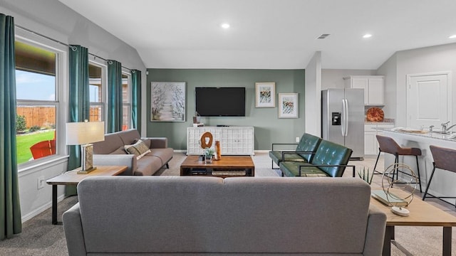 living room with vaulted ceiling, light carpet, baseboards, visible vents, and recessed lighting