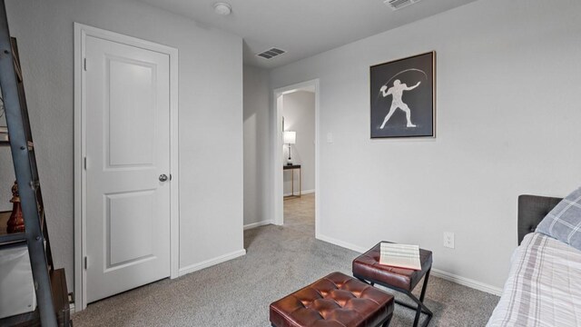bedroom featuring carpet floors, visible vents, and baseboards
