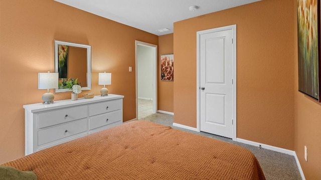 carpeted bedroom featuring baseboards