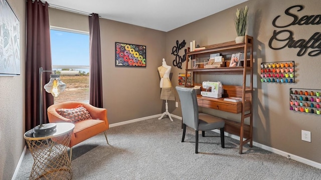 carpeted home office featuring a water view and baseboards