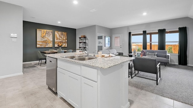 kitchen featuring a sink, open floor plan, dishwasher, white cabinetry, and recessed lighting
