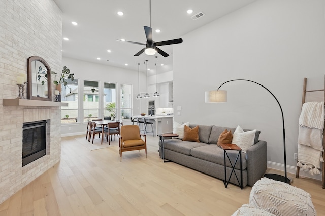 1808 Wren St, Argyle, TX 76226 - living area featuring light wood-type flooring, a fireplace, a ceiling fan, baseboards, and recessed lighting