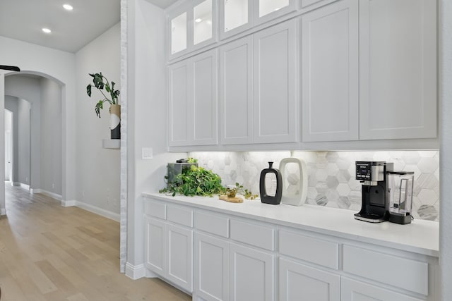 1808 Wren St, Argyle, TX 76226 - bar featuring arched walkways, baseboards, backsplash, light wood-style flooring, and recessed lighting