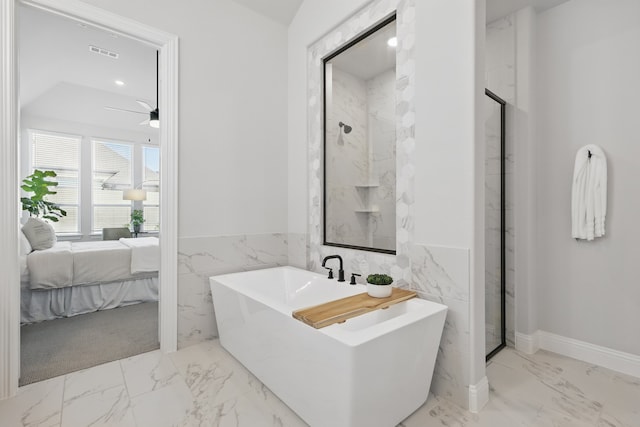 1808 Wren St, Argyle, TX 76226 - ensuite bathroom featuring marble finish flooring, tile walls, a freestanding tub, a wainscoted wall, and a stall shower