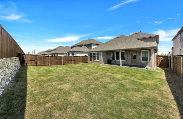 4321 Minnow Cove Rd, Oak Point, TX 75068 - rear view of house featuring a shingled roof, a patio area, a yard, a fenced backyard, and brick siding