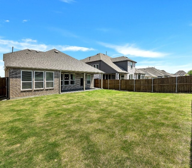 4321 Minnow Cove Rd, Oak Point, TX 75068 - rear view of house with a patio, brick siding, a fenced backyard, and a lawn
