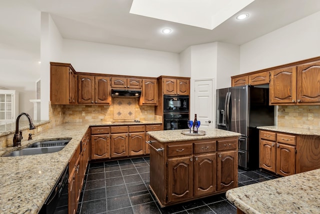 8405 Evening Star Dr, Rowlett, TX 75089 - kitchen featuring a sink, black appliances, under cabinet range hood, decorative backsplash, and a kitchen island