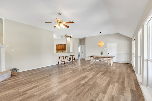 8405 Evening Star Dr, Rowlett, TX 75089 - living room featuring a ceiling fan, light wood-type flooring, vaulted ceiling, and baseboards