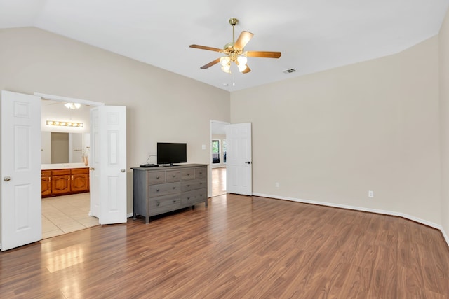 8405 Evening Star Dr, Rowlett, TX 75089 - bedroom with wood finished floors, lofted ceiling, baseboards, ensuite bath, and ceiling fan