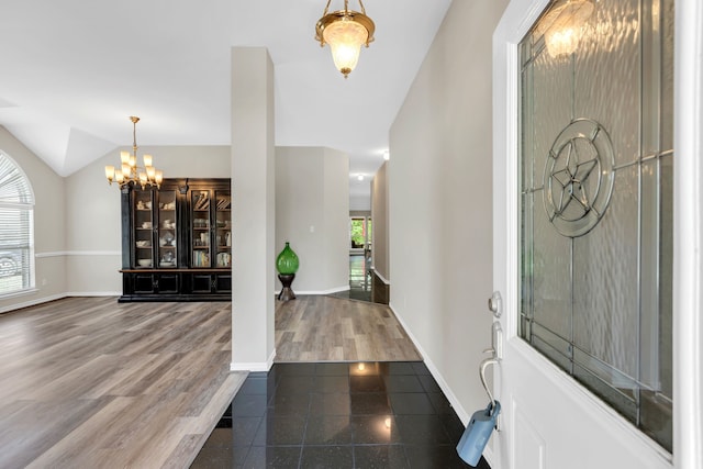 8405 Evening Star Dr, Rowlett, TX 75089 - foyer with a chandelier, lofted ceiling, baseboards, and wood finished floors