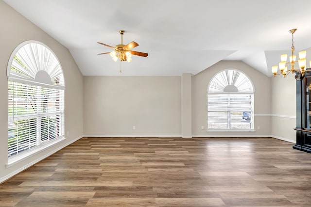 8405 Evening Star Dr, Rowlett, TX 75089 - empty room with lofted ceiling, a chandelier, ceiling fan, wood finished floors, and baseboards