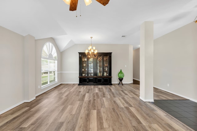 8405 Evening Star Dr, Rowlett, TX 75089 - unfurnished dining area featuring a chandelier, wood finished floors, a ceiling fan, baseboards, and vaulted ceiling