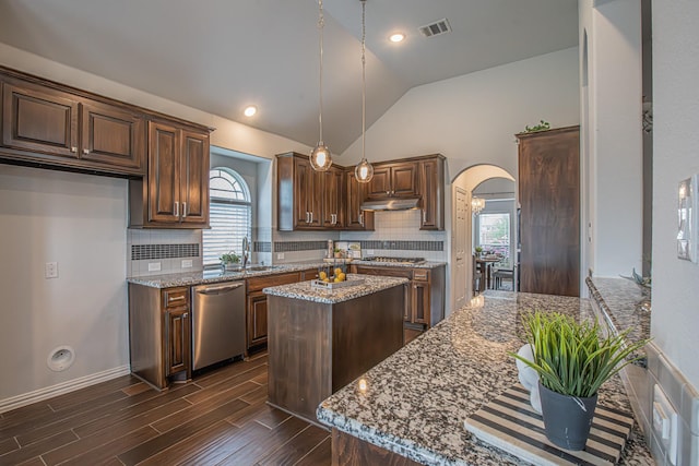 kitchen featuring stainless steel dishwasher, arched walkways, visible vents, lofted ceiling, and under cabinet range hood