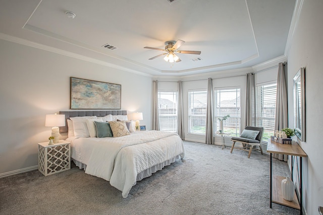 carpeted bedroom featuring visible vents, a raised ceiling, and crown molding