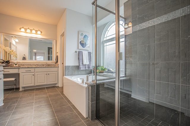 bathroom featuring a bath, vanity, tile patterned flooring, and a stall shower