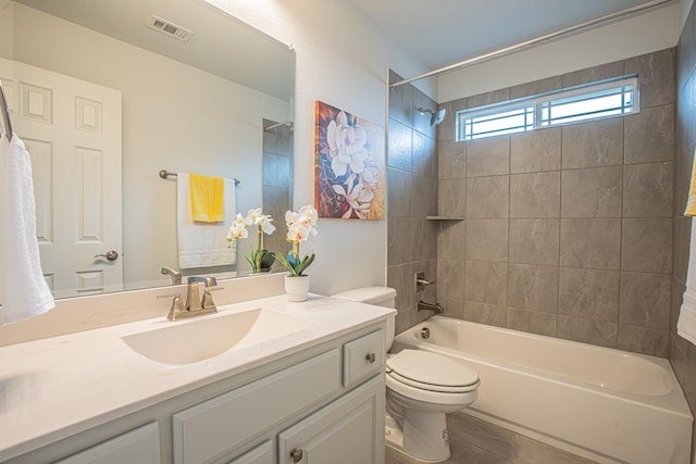 bathroom with vanity, shower / washtub combination, toilet, tile patterned flooring, and visible vents