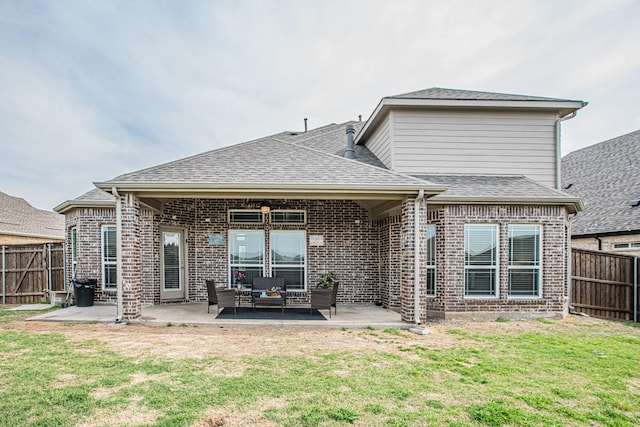 rear view of property featuring a fenced backyard, a yard, a patio area, and an outdoor hangout area